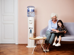 Oma mit Enkel und Alpenwasserspender