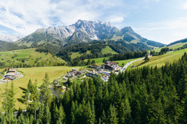 Vogelperspektive auf das &Uuml;bergossene Alm Resort eingebettet in die Landschaft. 
