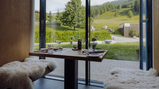 Gedeckter Tisch in der Bar Freiraum im Naturresort Puradies mit Blick ins Gr&uuml;ne.