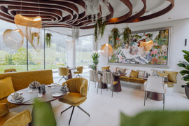 edeckte Tische im Gourmetrestaurant Ess:enz im Naturresort Puradies mit Blick ins Gr&uuml;ne.