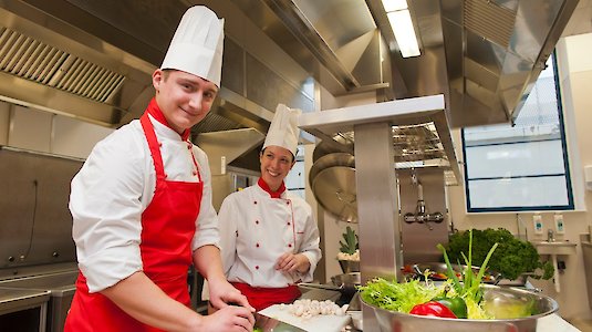 Köche haben eine Freude bei der Zubereitung von gesundem Essen