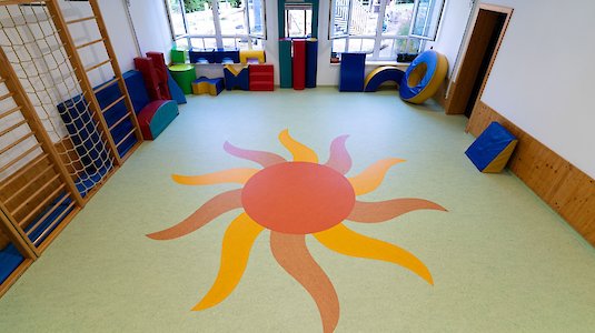 Kindergarten exercise room with sun in the flooring. Copyright by True Photo by Oliver Erenyi.